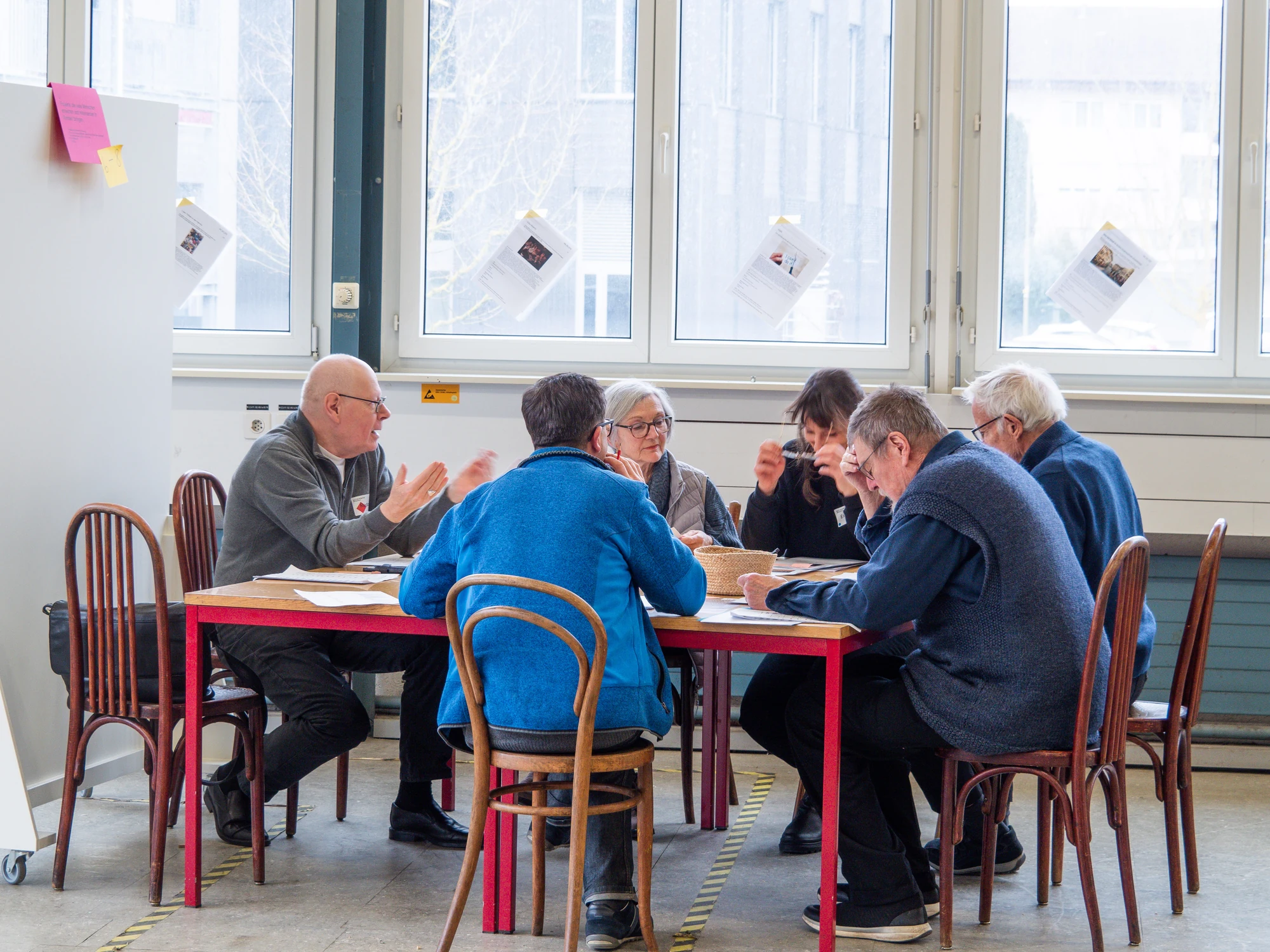 Residents discussing project material around a table