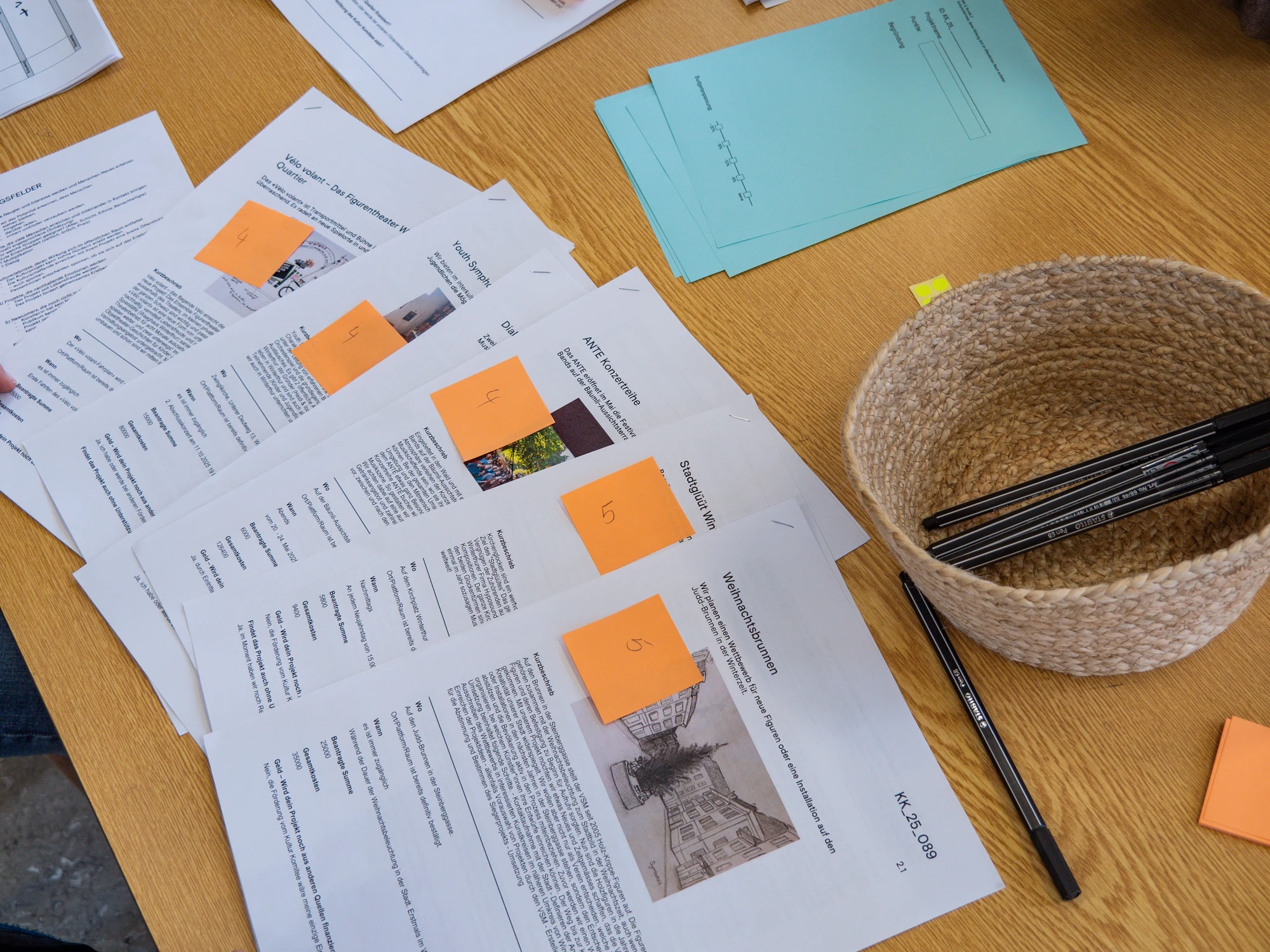 Project briefs, assessment sheets and annotations on a working table